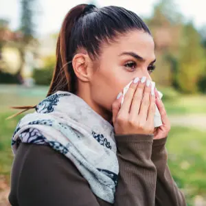 woman wiping her nose