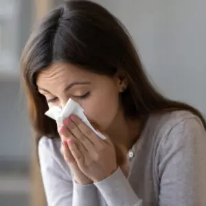 woman blowing her nose