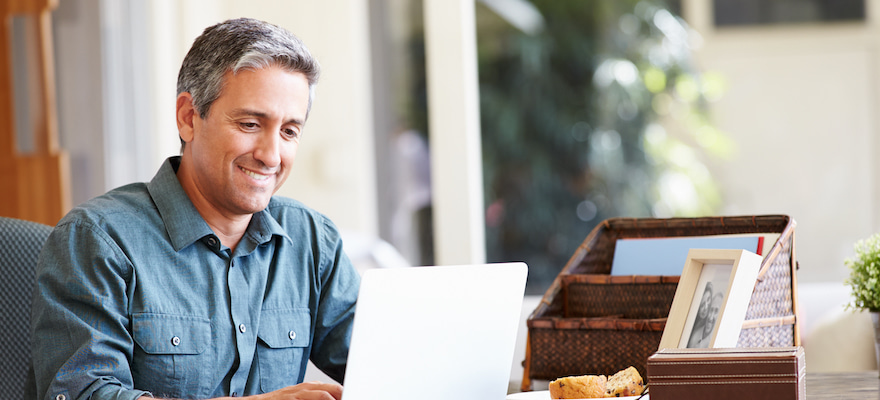 man using a laptop smiling