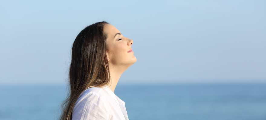 woman breathing easy at the beach